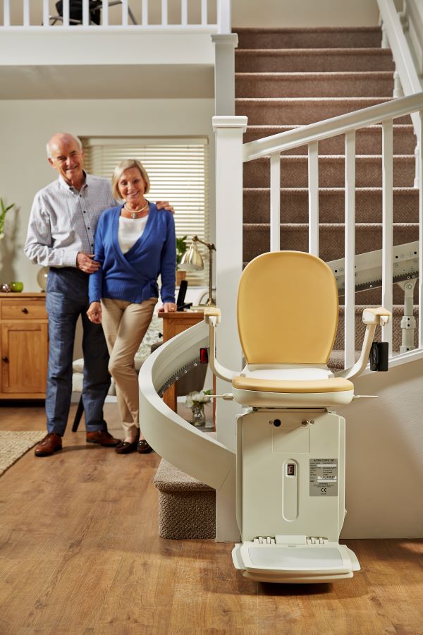 elderly couple admiring their acorn chair lift